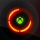 A stylized image shows an Xbox power button and logo with the red-ring error symbol.